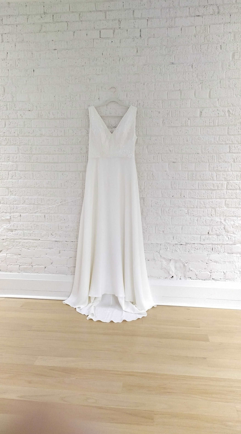 Off the rack wedding dress. Size 14, simple fit and flare crepe wedding gown. V neck, bra friendly wedding dress. Handmade in Toronto.