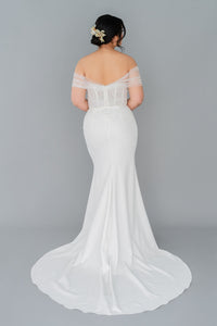 Romantic off the shoulder wedding dress by Catherine Langlois. Fit and flare silhouette accentuates the body in a modern intrepretation of delicate design. Inclusive size wedding dresses made in Canada.