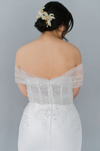 Romantic off the shoulder wedding dress by Catherine Langlois. Fit and flare silhouette accentuates the body in a modern intrepretation of delicate design. Inclusive size wedding dresses made in Canada.