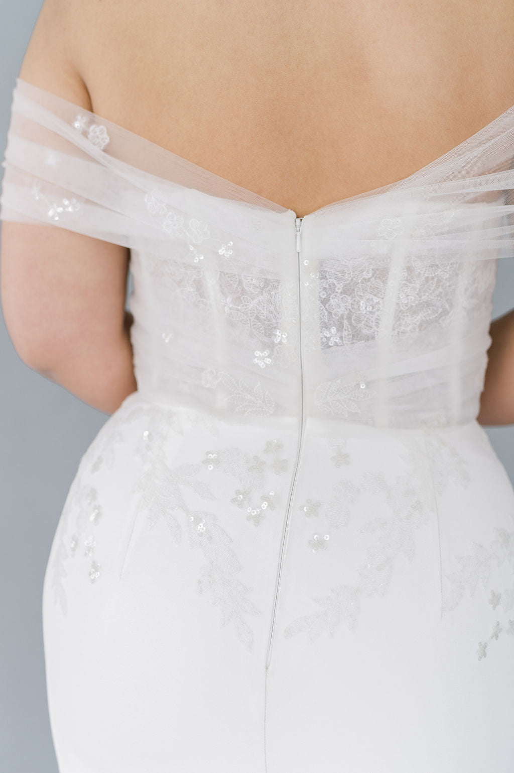 Romantic off the shoulder wedding dress by Catherine Langlois. Fit and flare silhouette accentuates the body in a modern intrepretation of delicate design. Inclusive size wedding dresses made in Canada.