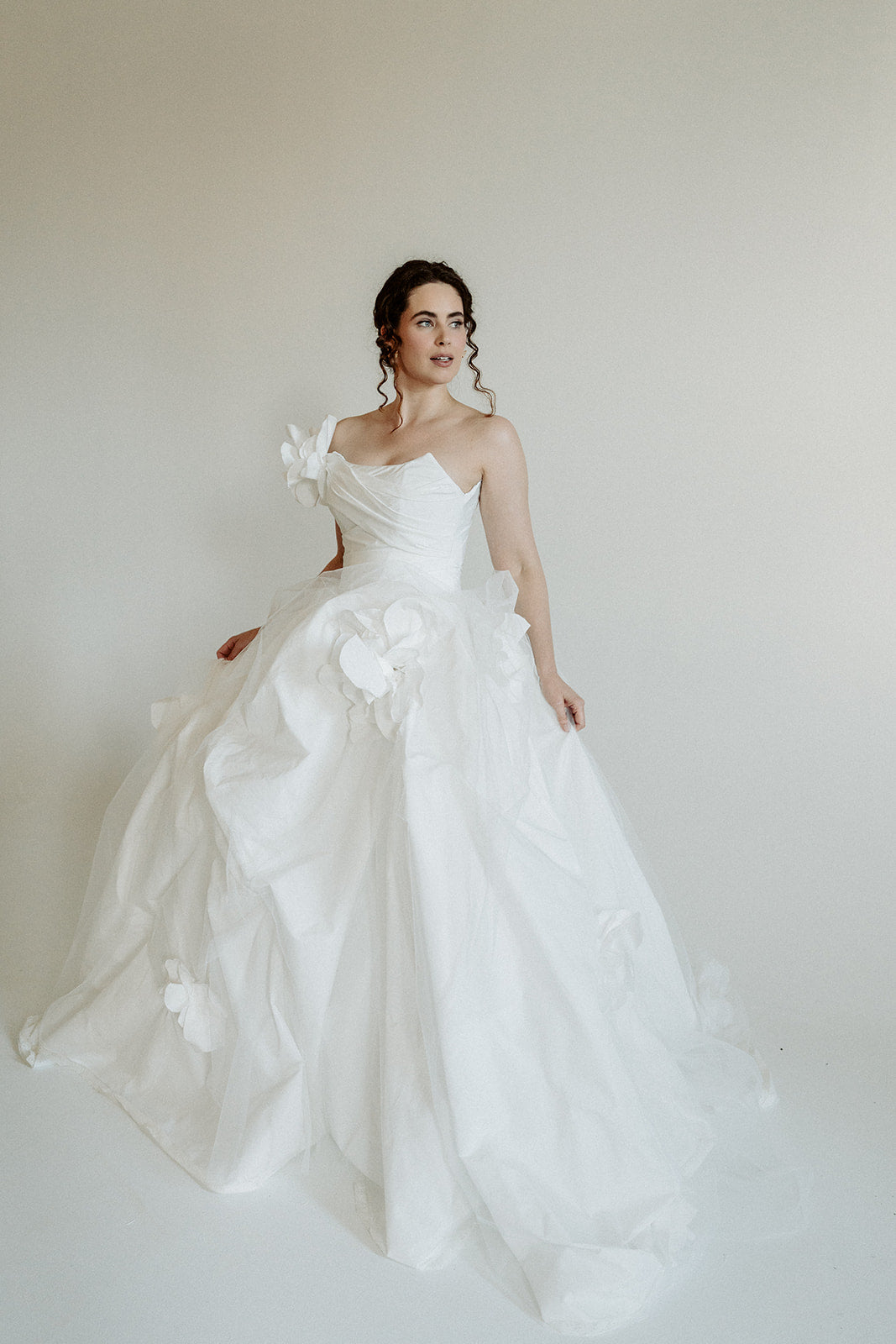 Made to measure designer corset wedding dress. Handmade roses on tulle. Designed in our atelier in Toronto, Canada.