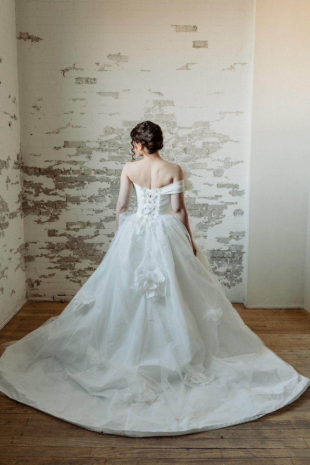 Made to measure designer corset wedding dress. Pleated top, lacing, ballgown. Designed in our atelier in Toronto, Canada.