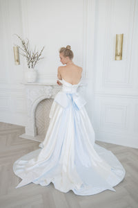 Dramatic satin wedding gown with a big bridal bow. Demi couture wedding attire by Catherine Langlois, Toronto