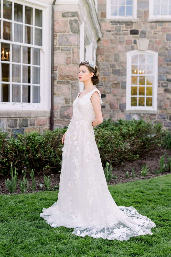 Romantic whimsical lace wedding dress with off the shoulder neckline. Designed by Canadian wedding dress designer Catherine Langlois , Toronto