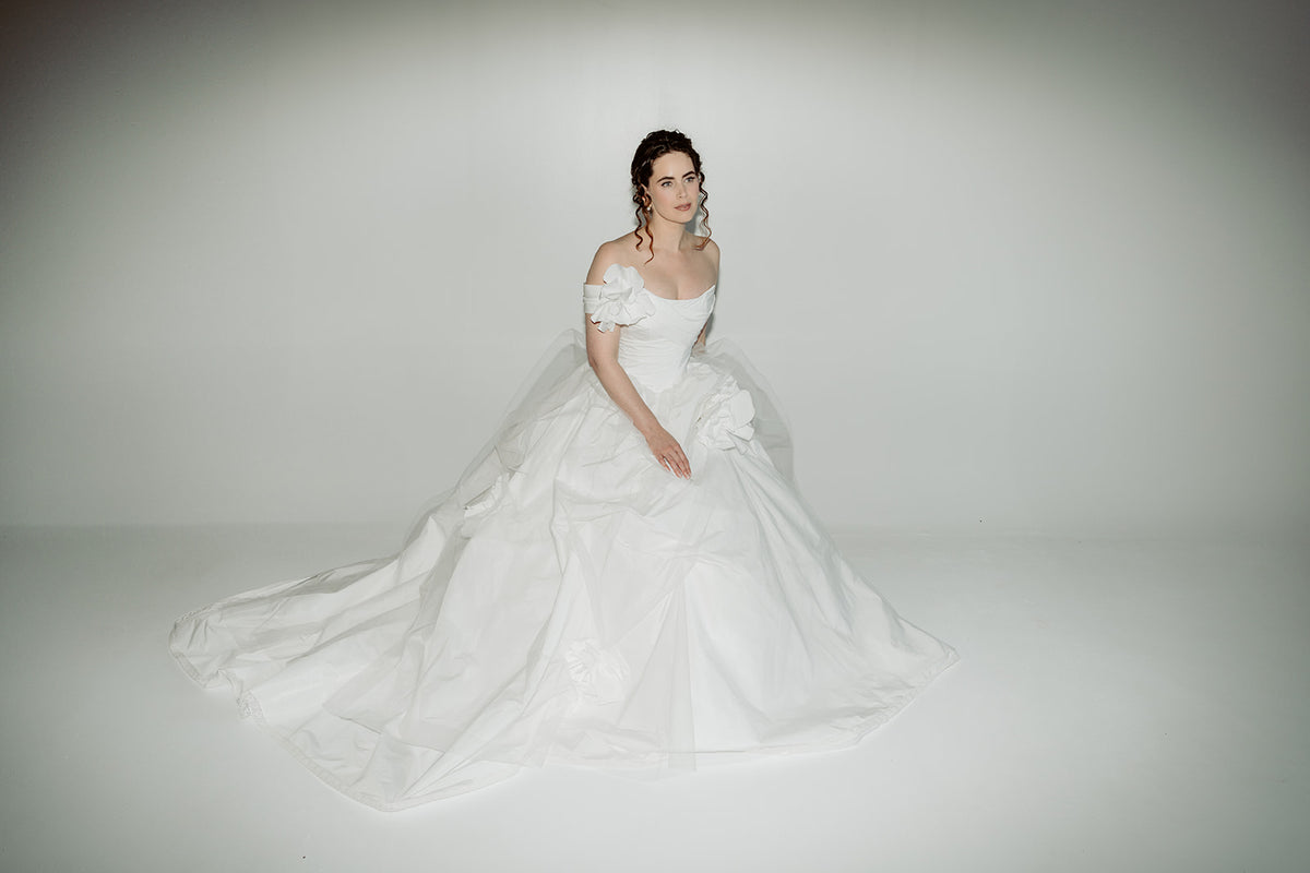 Made to measure designer corset wedding dress ballgown. Handmade roses on tulle. Designed in our atelier in Toronto, Canada.