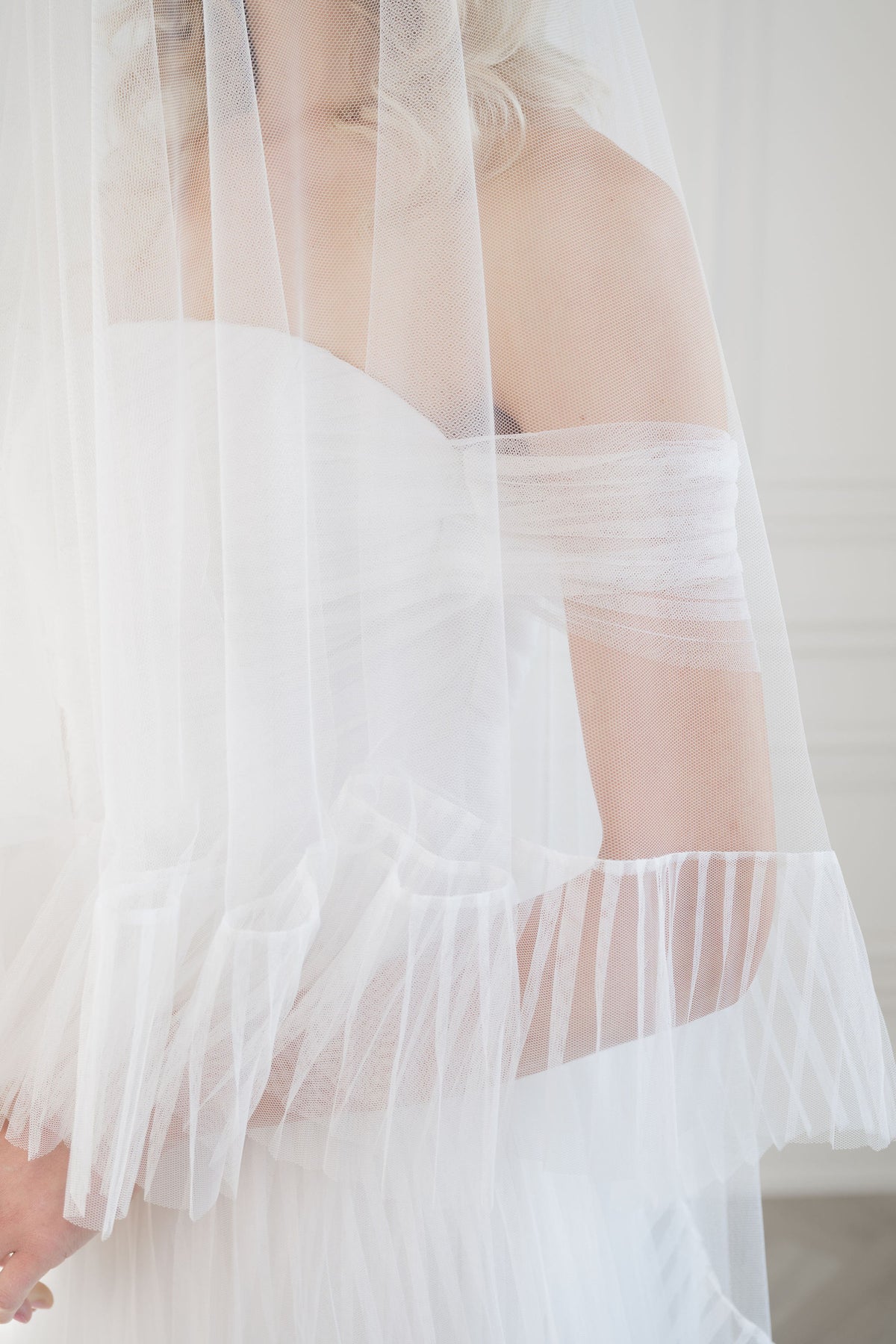 Modern pleated tulle wedding dress.  Strapless with arm bands. Custom  made bridal gowns for refined brides by Catherine Langlois, Toronto.