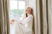 Custom designed blush satin evening gown. Long sleeves, high neck. Catherine Langlois bridal gowns Toronto bridal boutique.