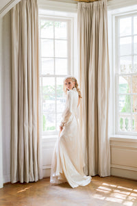 Custom designed blush silk satin evening wedding gown. Long sleeves, high neck. Catherine Langlois bridal gowns Toronto bridal boutique.