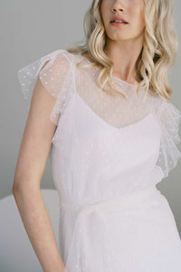 Nostalgic and romantic dotted tulle wedding dress. Whimsical ruffles cascade down the front and back.Shown with a simple slip dress lining. Designed by Catherine Langlois, Canada.