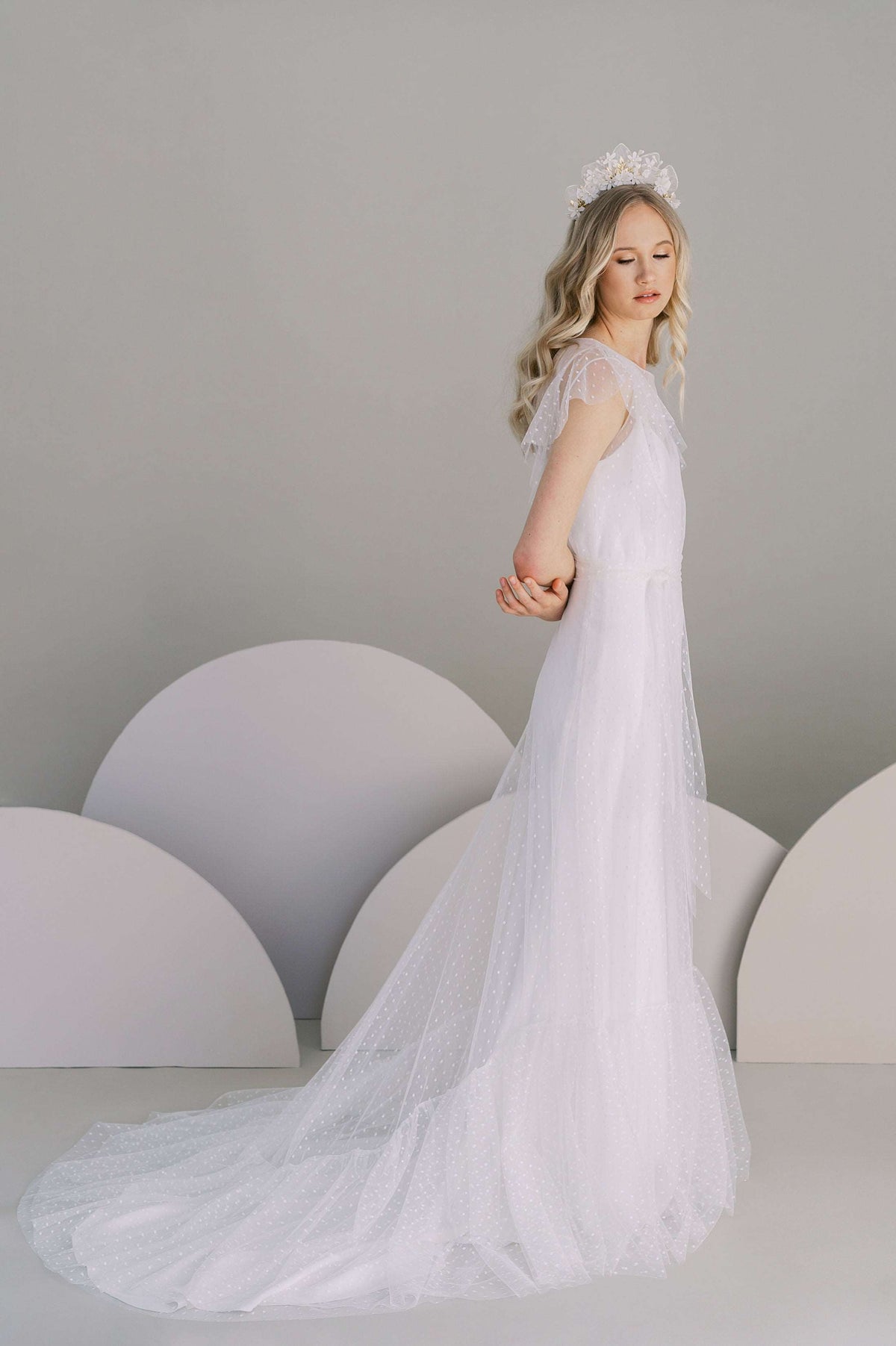 Understated slip wedding dress with a low v back. Available in silk or eco crepe. Shown with the Alsking dotted tulle overdress.Made to order by Catherine Langlois, Toronto, Canada.