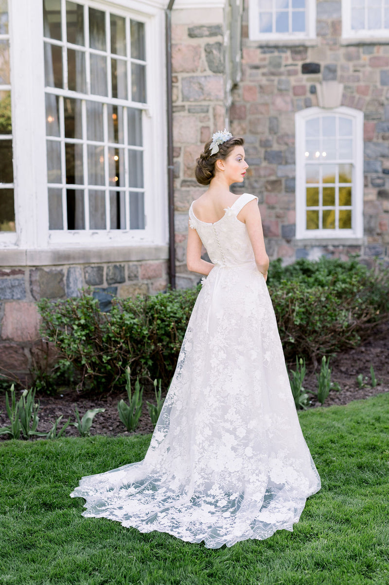 Romantic lace wedding dress with off the shoulder neckline. Designed by Catherine Langlois in Toronto, Ontario, Canada.