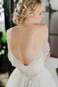 Ethereal off the shoulder Canadian wedding dress. Custom designed romantic wedding dresses custom made in Toronto. Shop our local Toronto bridal studio.