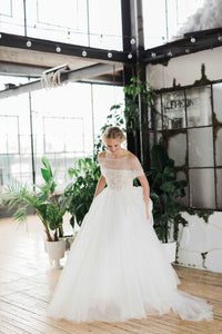 Ethereal off the shoulder Canadian wedding dress. Custom designed luxury wedding dresses custom made in Toronto. Corset off the shoulder bridal gown.Shop our local Toronto bridal studio.