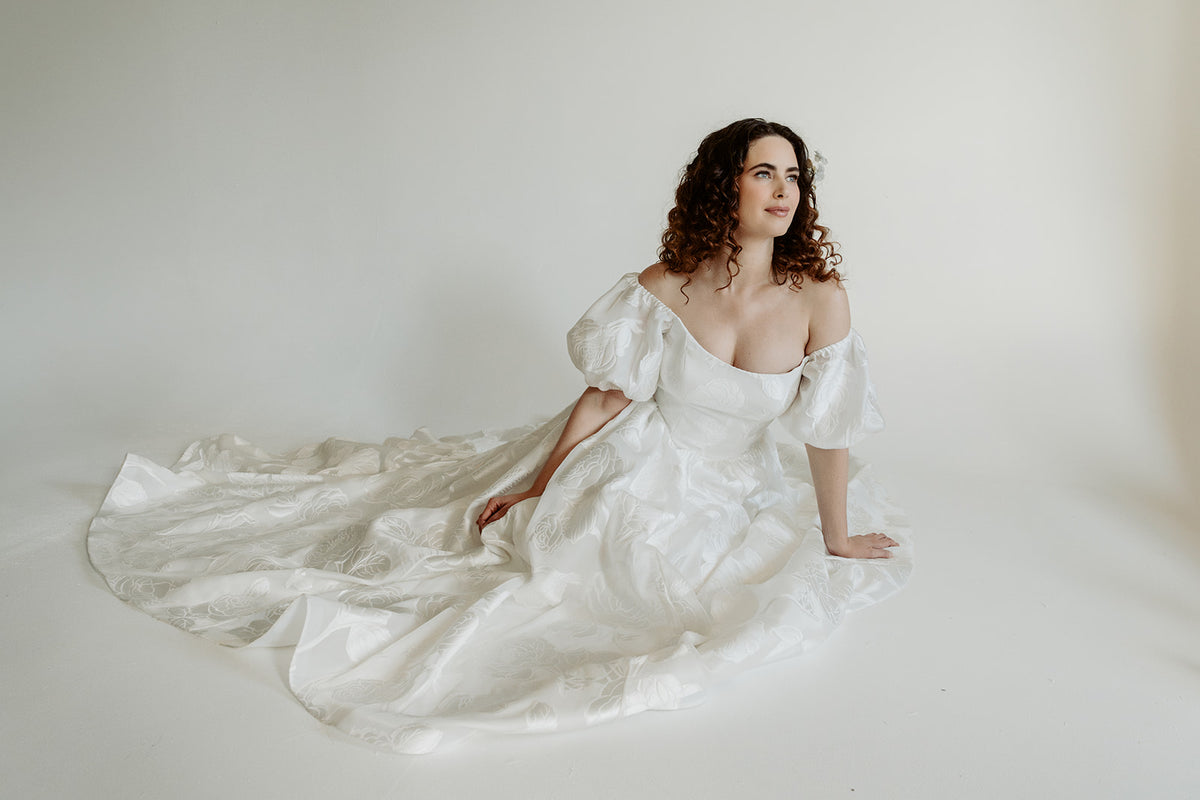 Romantic textured wedding dress. Off the shoulder, puffed sleeves. Custom made in our studio Toronto, Canada.