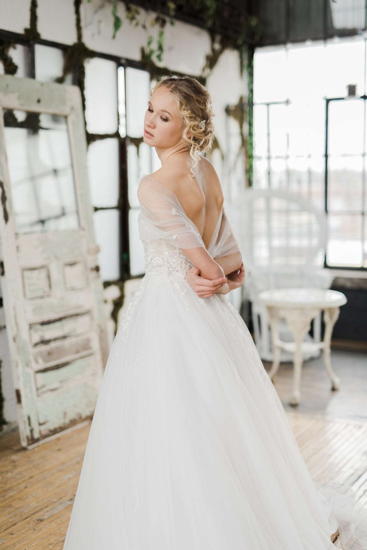 A modern princess wedding dress with yards of beaded and appliqued tulle. Designed and hand made by Catherine Langlois in Toronto, Ontario.