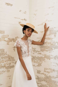 Simple crepe and lace wedding dress designed by Catherine Langlois. Modern lace with hints of pewter and an elegant A line skirt.