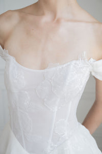 Sheer corset dropped waist wedding dress. Beautiful, airy layers of silk organza. Custom designed by Catherine Langlois, Toronto.