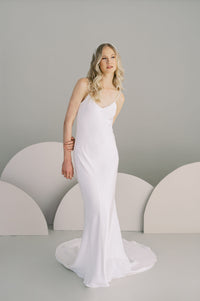 Understated slip wedding dress with a low v back. Available in silk or eco crepe. Made to order by Catherine Langlois, Toronto, Canada.