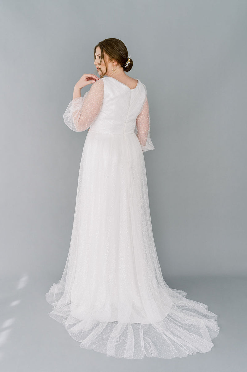 Romantic sparkly tulle wedding dress by Catherine Langlois. 3/4 poet sleeves, full gathered skirt, V neckline front and back. Timeless and glamorous.