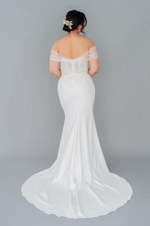 Romantic off the shoulder wedding dress by Catherine Langlois. Fit and flare silhouette accentuates the body in a modern intrepretation of delicate design. Inclusive size wedding dresses made in Canada.