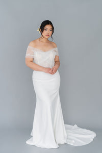Romantic off the shoulder  wedding dress by Catherine Langlois. Fit and flare silhouette accentuates the body in a modern intrepretation of delicate design. Inclusive size wedding dresses made in Canada.