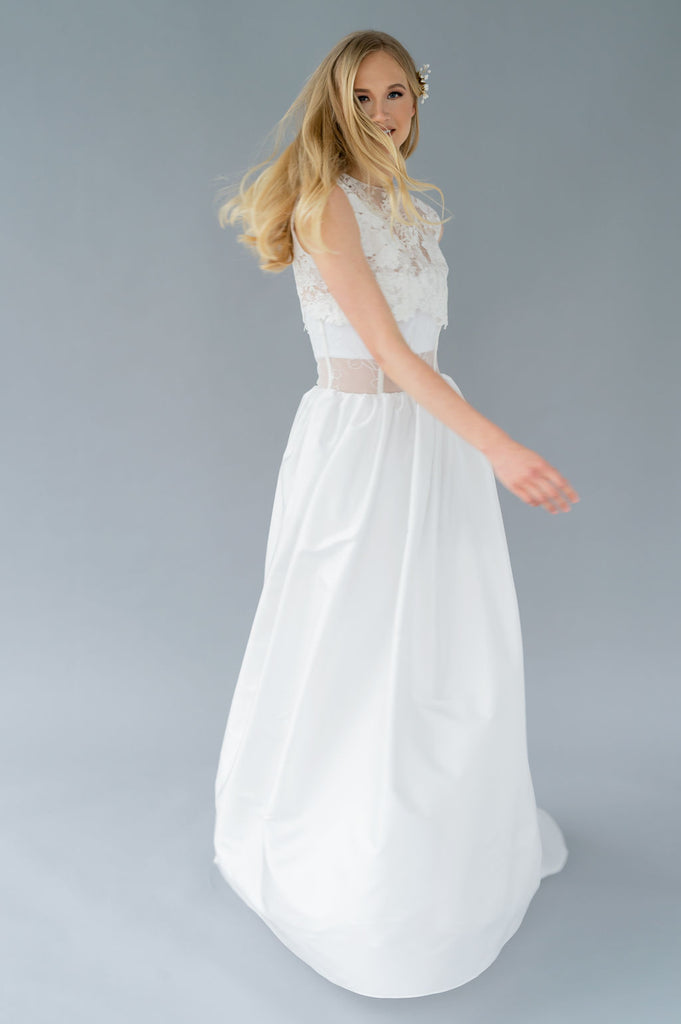 Playful romantic wedding dress, handmade by Catherine Langlois. Features pockets, a removable topper and corset detailing.