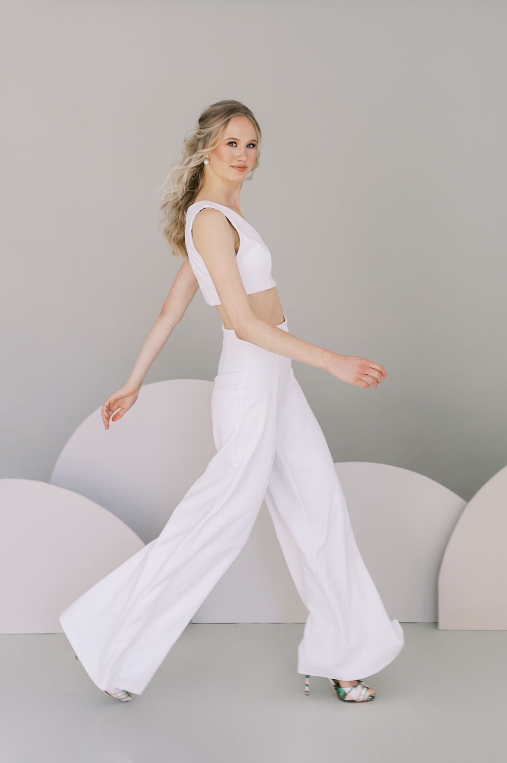 Modern wedding pants for an informal bridal outfit. Stretch crepe palazzo trousers with a tapered fit at the waist. Designed by Catherine Langlois, Canada.