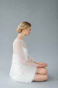 Short, fun wedding dress by Catherine Langlois. Beaded tulle with bell sleeves and a crepe slip. Made in Canada.