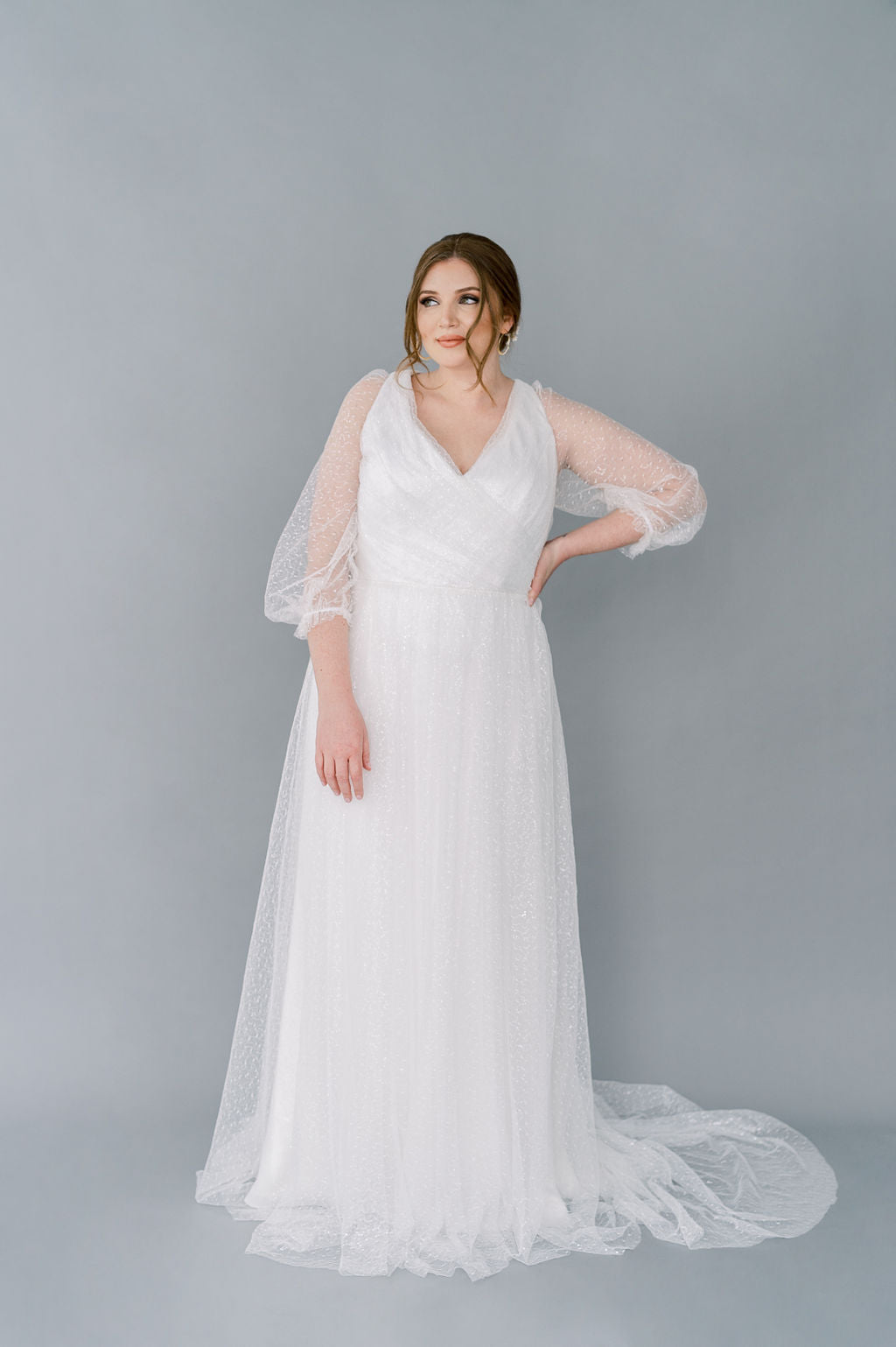 Romantic sparkly tulle wedding dress by Catherine Langlois. 3/4 poet sleeves, full gathered skirt, V neckline front and back. Timeless and glamourous.