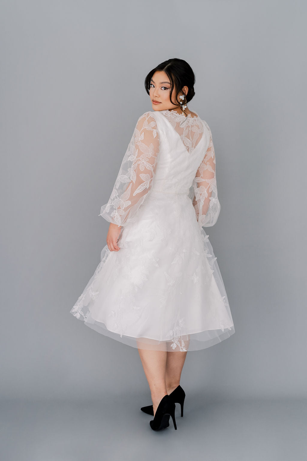 Lace tea length wedding dress with long poet sleeves and a line skirt. Custom made to order by Catherine Langlois, Toronto.