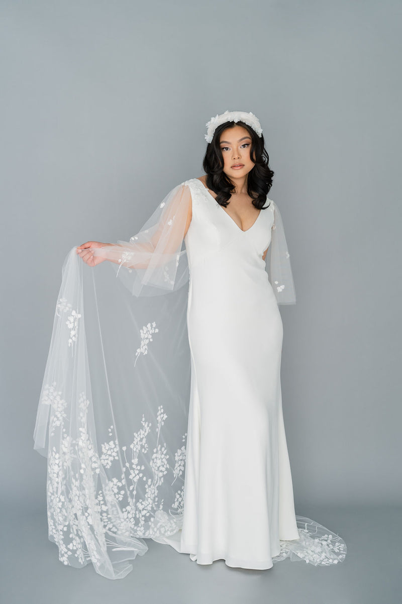 Romantic Canadian wedding dress. Classic crepe and tulle wedding dress. Whimsical 3D applique with tulle flutter sleeves and train. Empire line and V neckline. Custom made in Toronto by Catherine Langlois.