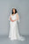 Romantic yet classic crepe and tulle wedding dress. Whimsical 3D applique with tulle flutter sleeves and train. Empire line and V neckline. Custom made in Toronto by Catherine Langlois.