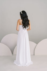 Simple empire line crepe wedding dress. Spaghetti straps and puddle train. Handmade in Canada by Catherine Langlois.