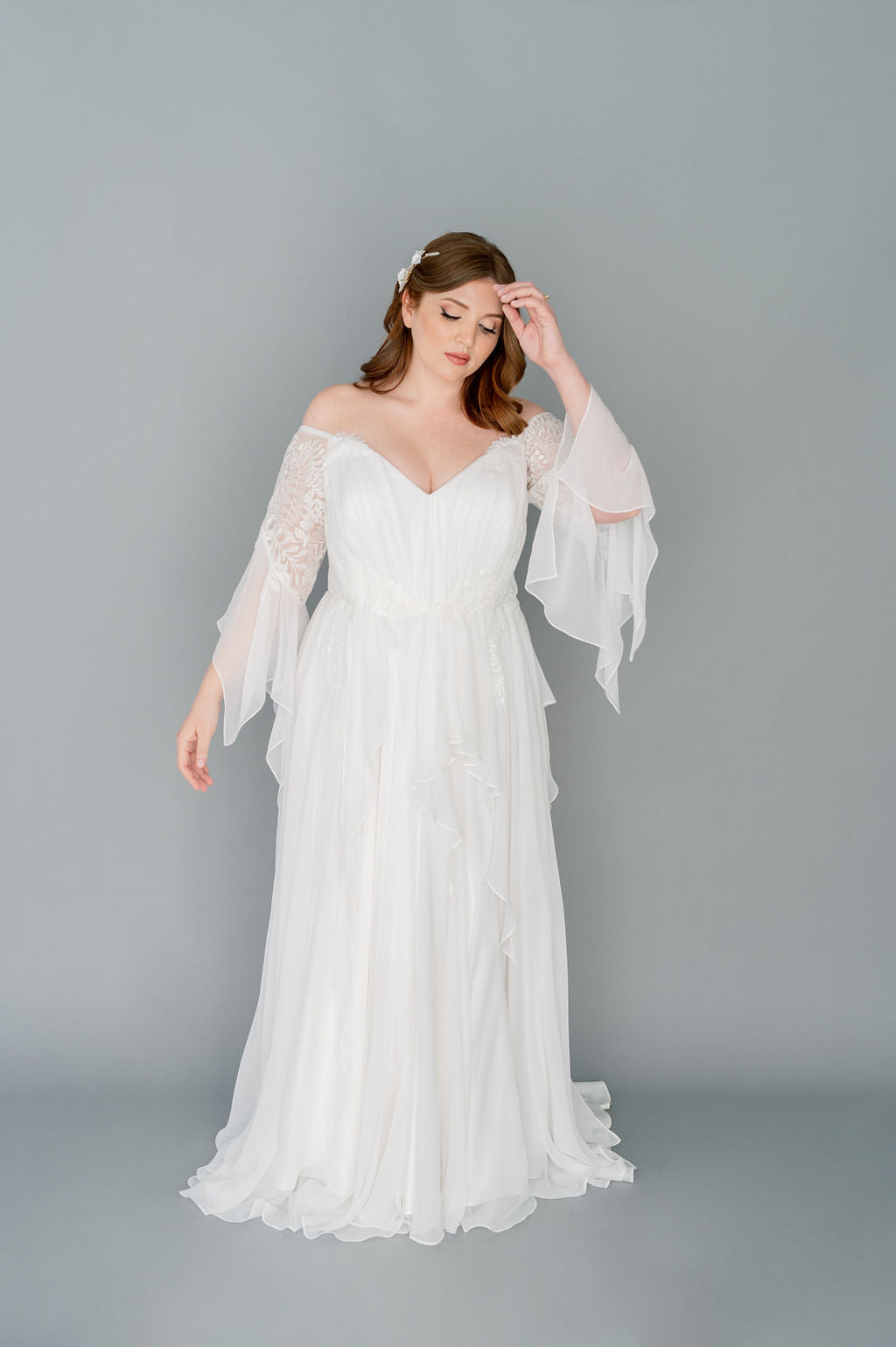 Romantic silk chiffon wedding dress by Catherine Langlois. Boho styling with a full gathered skirt and floaty details. Beaded leaf lace, 3/4 sleeves.