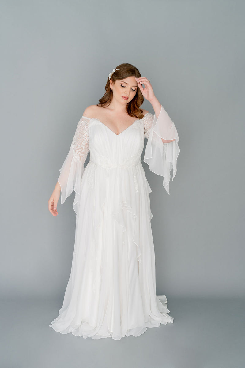 Romantic silk chiffon wedding dress by Catherine Langlois. Boho styling with a full gathered skirt and floaty details. Beaded leaf lace, 3/4 sleeves.